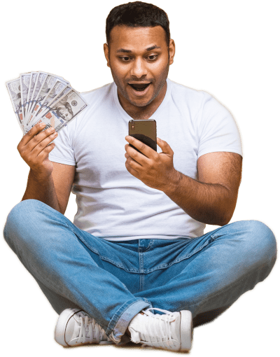 Man surprised looking at phone with money in the hand